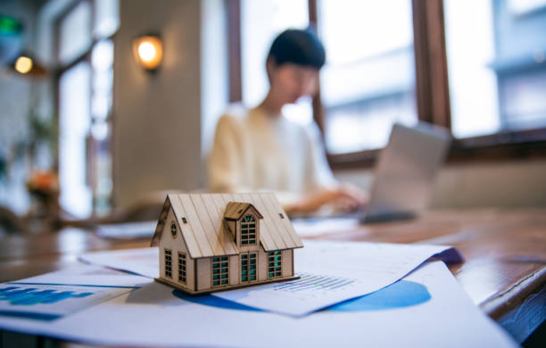 Real Estate Agent Working On Laptop